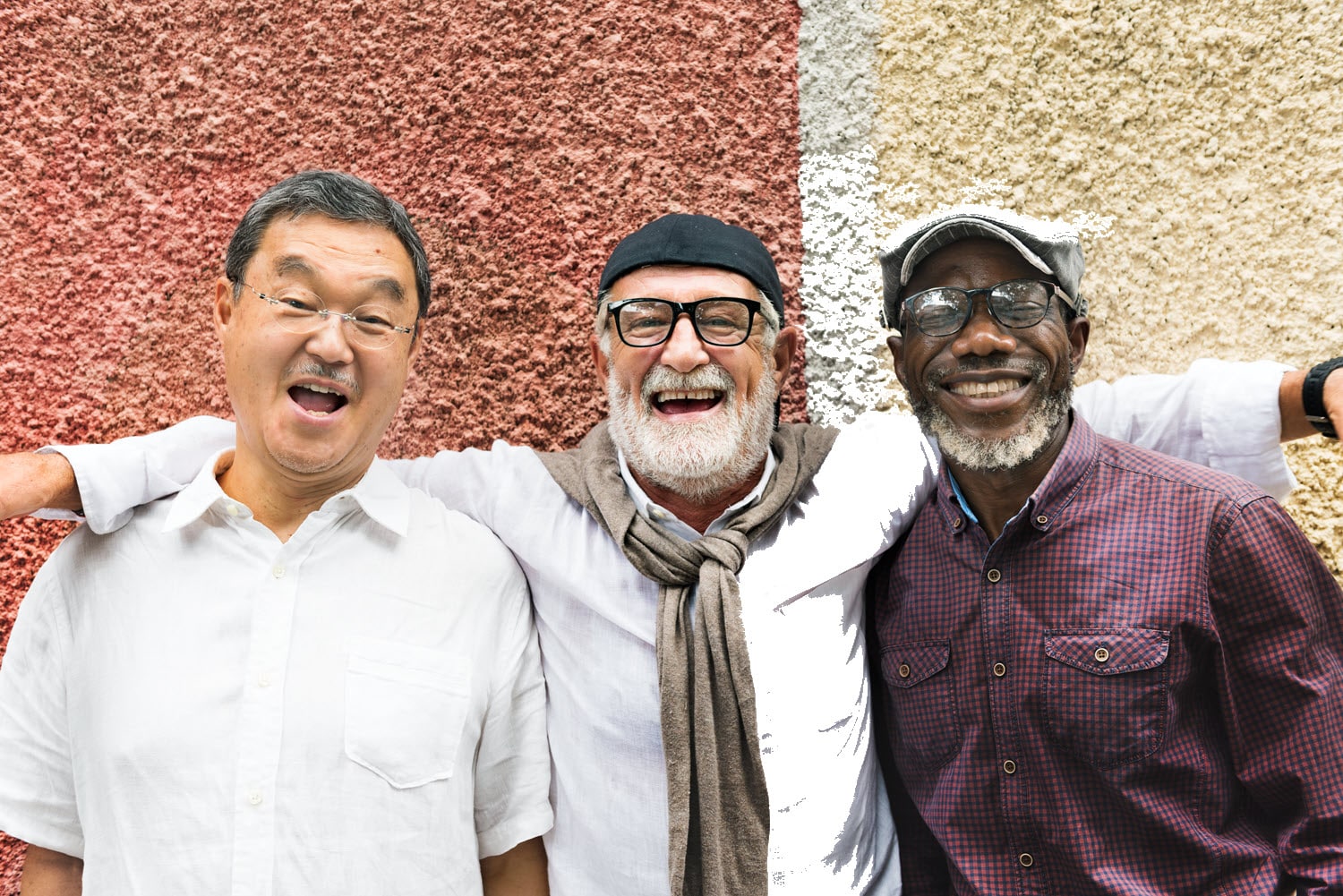 PAE-CoverImage-1500x1000 3 men standing in front of a stucco wall, smiling, with their arms around each others' shoulders